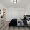 Furnished bedroom with sliding-door closet and modern black-and-white decor