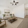 Open living room with vaulted ceiling leading to the bedroom hallway