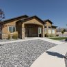 Eagle Heights Village clubhouse with stone accents and landscaped walkways