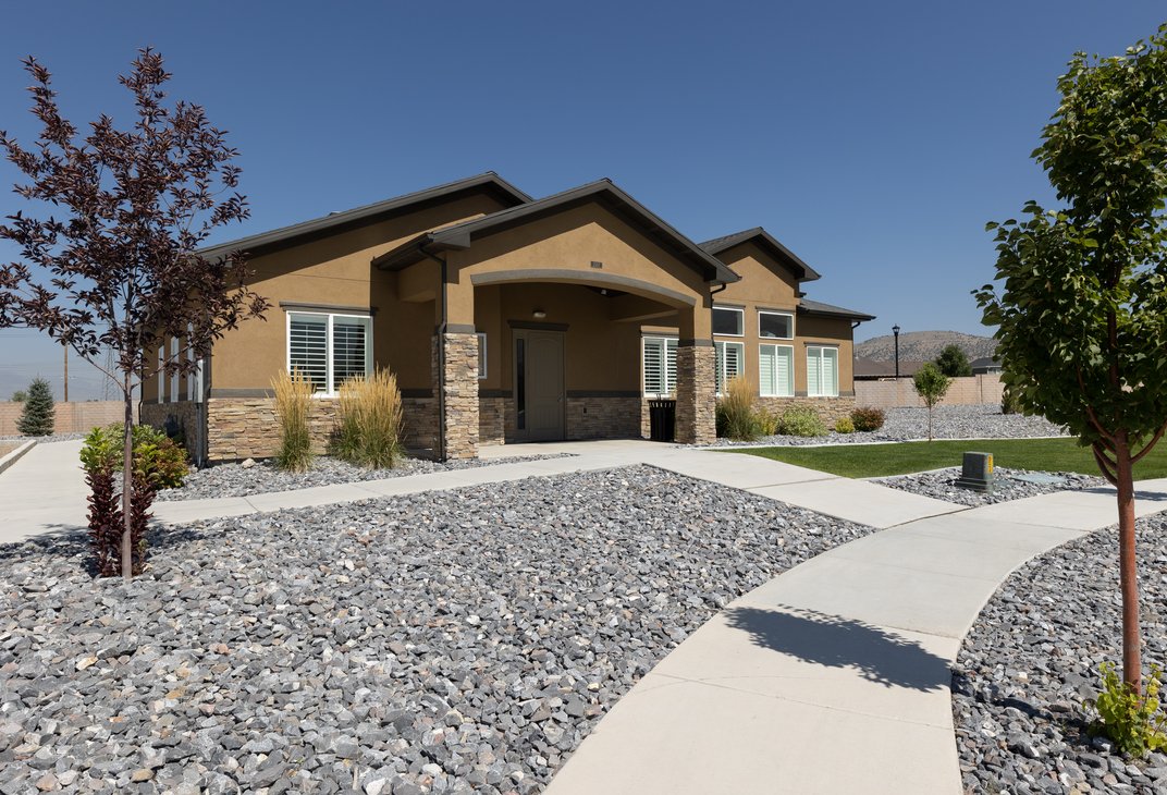 Eagle Heights Village clubhouse with stone accents and landscaped walkways