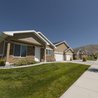 Row of single-level homes with attached garages and mountain views