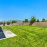 Private fenced backyard with lawn and patio